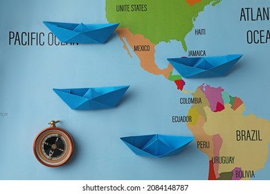 Bright Paper Boats And Compass On World Map, Flat Lay