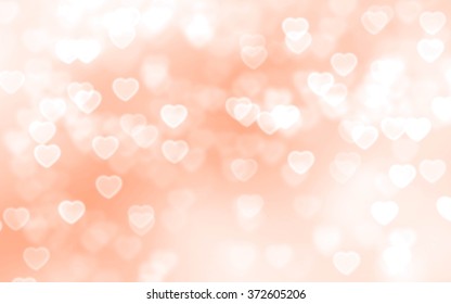 Bright peach color heart-shaped bokeh background