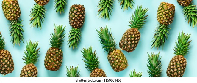 Bright pineapple pattern for minimal style. Top View. Pop art design, creative concept. Copy Space. Banner. Fresh pineapples on blue background