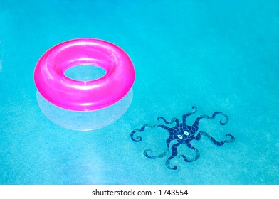 Bright Pink Innertube Floating In The Pool