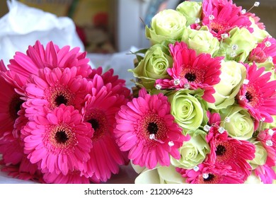 Bright pink red and green flowers in brides bouquet. Beautiful daisies in floral arrangement for special wedding day occasions. Vibrant decorative bunch of flowers. - Shutterstock ID 2120096423