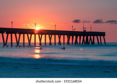 A Bright Pink Sky And Still Blue Waters At Sunrise At Johnnie Mercer's Fishing Pier