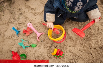 Bright Plastic Children Toys In Sandpit Or On A Beach