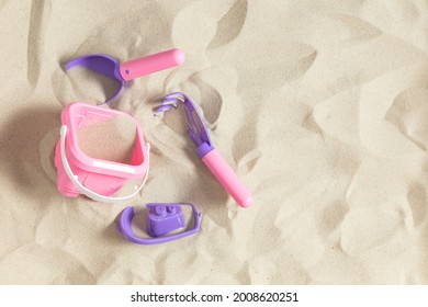 Bright Plastic Children's Toys In Sand. Concept Of Beach Recreation For Children. Top View.  Flat Lay, Top View, Copy Space