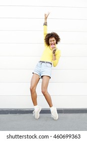 Bright Portrait Of Happy Modern Young Black Woman Eating Donuts In The City. Outdoors, Lifestyle