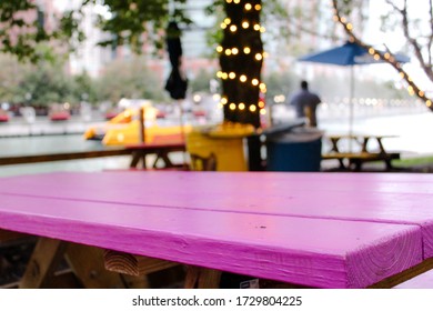 Bright Purple Wood Picnic Table Near The Chicago River On A Cloudy Day In The City Of Chicago