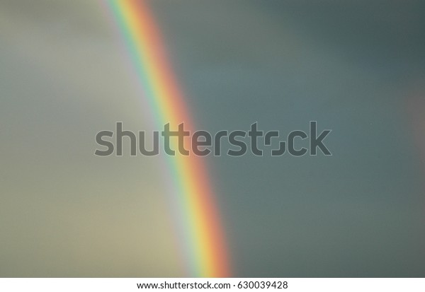 bright\
rainbow dividing sky/rainbow/spectral\
colors