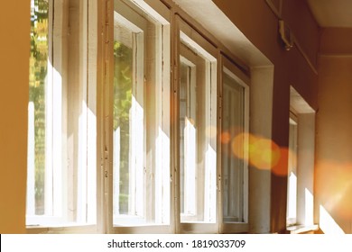 bright ray of sun illuminate room through wooden window old frame side view