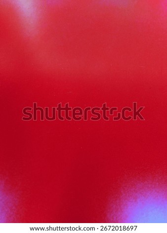 A bright red background with diffused, colorful bokeh lights creating a dreamy, abstract effect.