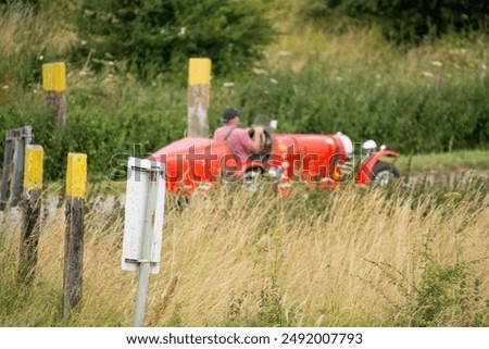 a bright red bugatti type 35B replica open-top sports car, 1971 volkswagen 1285cc underpinnings, driven through countryside