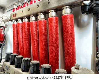 Bright red fire hoses are organized and stored in a fire station, ready for immediate use in emergencies. - Powered by Shutterstock