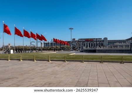 Bright red flags flutter in the breeze at Tiananmen Square, showcasing China's history and spirit.