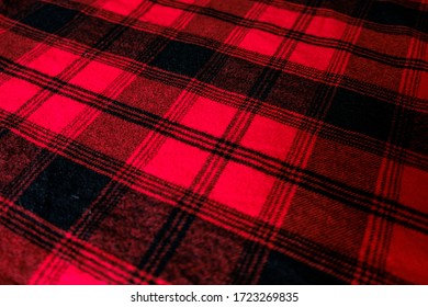 Bright Red Geometric Background Texture. Warm Red And Black Pattern. Wrinkled Shirt Surface At Home. Close Up Winter Wrap For Coziness. Soft Material To Cover Up On Cold Autumn Days. Side Angle.