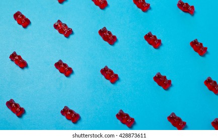 Bright Red Gummy Bears On Bright Blue Background