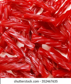 Bright Red Licorice Candy shaped like a twisted rope on backgounrd