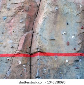 A bright red line painted climbing rock  text space above the line 