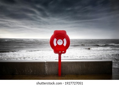 Bright Red Modern Lifebuoy Ring Water Rescue On Stormy Sea Sky, Big  Ocean Waves On Coastline. Life Saving Equipment Belt Preserver Emergency Station Help Prevent Drowning Dramatic Threatening Storm