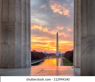 Bright red and orange sunrise at dawn reflects Washington Monument in new reflecting pool by Lincoln Memorial