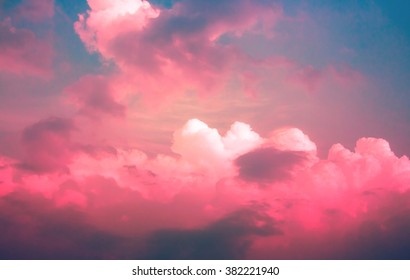 Bright Red Pink Neon Light On Clouds With Dim Blue Sky