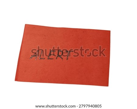 A bright red rectangular piece of paper featuring the handwritten word Alert, used to signify important messages or emergency warnings.