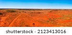 Bright red soil of australian outback at Broken hill city on Barrier highway in aerial landcape panorama.