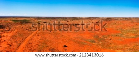 Bright red soil of australian outback at Broken hill city on Barrier highway in aerial landcape panorama.