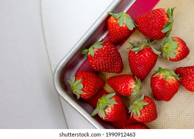 Bright, Red Strawberries On A Baking Sheet With A White Background