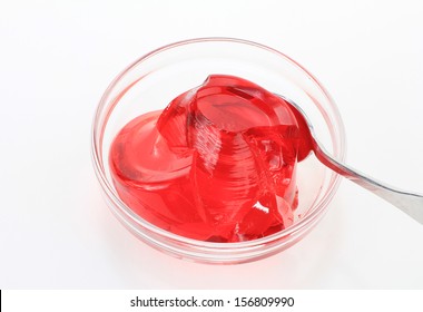 Bright Red Strawberry Jello In Clear Glass Bowl Against White Background.