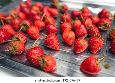 Bright red sweet strawberry on a white table