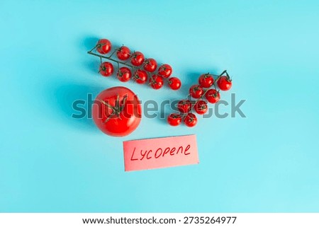 Bright red tomatoes and cherry tomatoes in close-up on a light background with the inscription 
