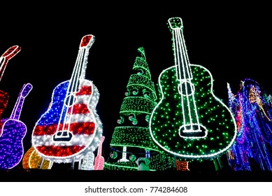 Bright Red, Red White And Blue And Purple And Green Guitars And Holiday Tree With Ornaments Lit Up With Lights At Mozart's Coffee  On Lake Travis In Austin, Texas