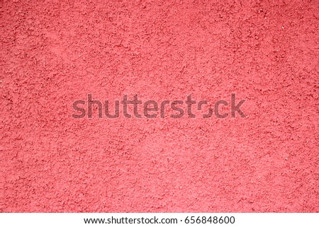 Bright redish pebbledash wall texture