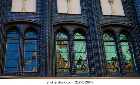 Bright Reflections In The Old Windows Of A Brick Gothic Building 