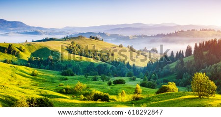 Bright rolling countryside around a farm in the morning light. Picturesque day and gorgeous scene. Location place Carpathian, Ukraine, Europe. Concept ecology protection. Explore the world's beauty. 商業照片 © 