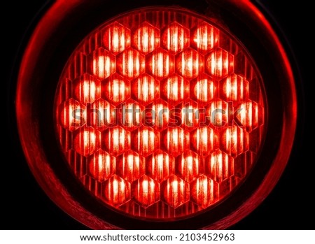 Bright round red light in the dark, object macro, detail, closeup, circle shape, nobody. Red alert, emergency alarm, warning, anxiety, stop abstract design concept, modern background texture, backdrop
