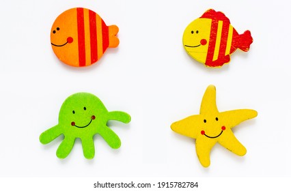 Bright Sea Creatures Kids Handmade Figures Set. Two Fish, Seastar And Octopus. Flat Wooden Children's Toys Collection, White Background Isolated. A Template For A Collage Of Animated Figures Top View