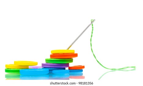 Bright Sewing Buttons And Needle With Thread Isolated On White