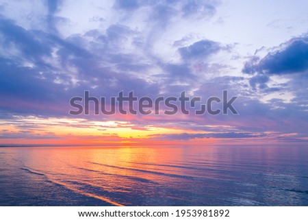 Bright sky. Beautiful colorful sunset over Baltic sea in Jurmala resort, Latvia. Relax, vacation concept. Warm evening on beach. Summer mood