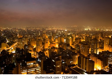 The Bright Skyline Of The City Of Sao Paulo, Brazil's Largest City, During The Evening/night. Countless Buildings And Shining Bright Yellow Lights Are Seen In This Photo Of The Brazilian Metropolis. Soft Focus