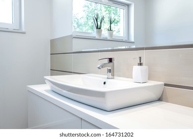 Bright space - a silver tap in a white bathroom