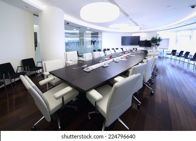 Bright And Spacious Conference Hall With Long Negotiating Table And White Chairs In Office 