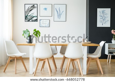Bright spacious dining room with wooden big table