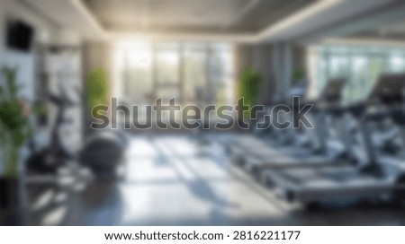 A bright and spacious gym interior featuring rows of treadmills and large windows allowing natural sunlight to illuminate the space.