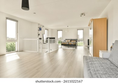 Bright and spacious modern interior showcasing a minimalist design with large windows and neutral furnishings, creating an inviting atmosphere.