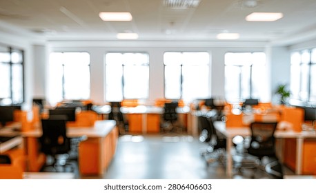 A bright and spacious office interior featuring numerous workstations, illuminated by ample natural light from large windows.