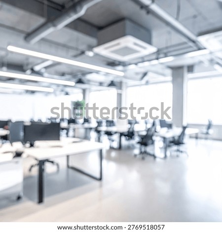 Bright and spacious open plan office interior featuring contemporary workstations, computers, and a clean, minimalist design.