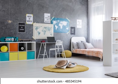 Bright, Spacious Room With Bed, Desk, Colourful Boxes And Posters On The Wall