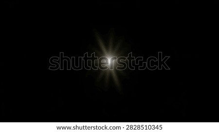 A bright starburst light effect emanates from a central point against a deep black background, creating a dramatic and luminous visual.