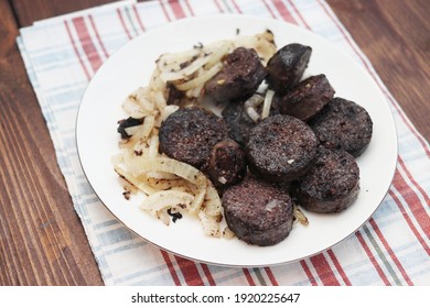 Bright still life with blood sausage in liver, homemade with fried onions. Delicious and healthy food made from natural products.