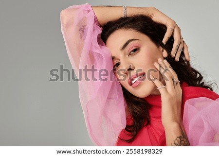 Similar – Image, Stock Photo Portrait of young bold African American female in long zipper coat confidently looking at camera standing on orange background